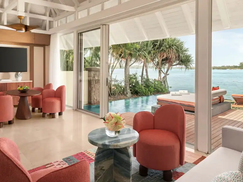 صورة: Four Seasons Resort Mauritius at Anahita: A bright villa living area opens onto a private pool and furnished deck beside the water.