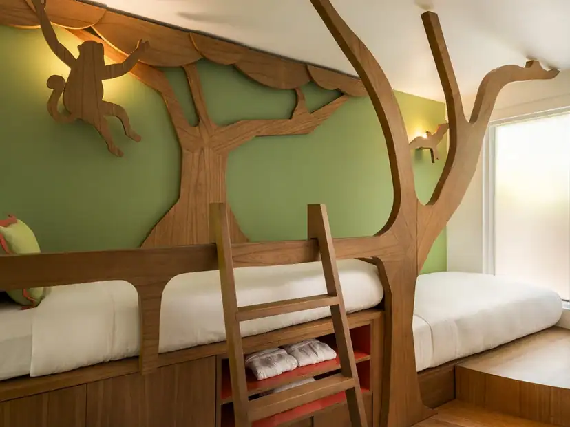 Constance Halaveli: A playful bedroom features white beds framed by a sculptural wooden tree and ladder.