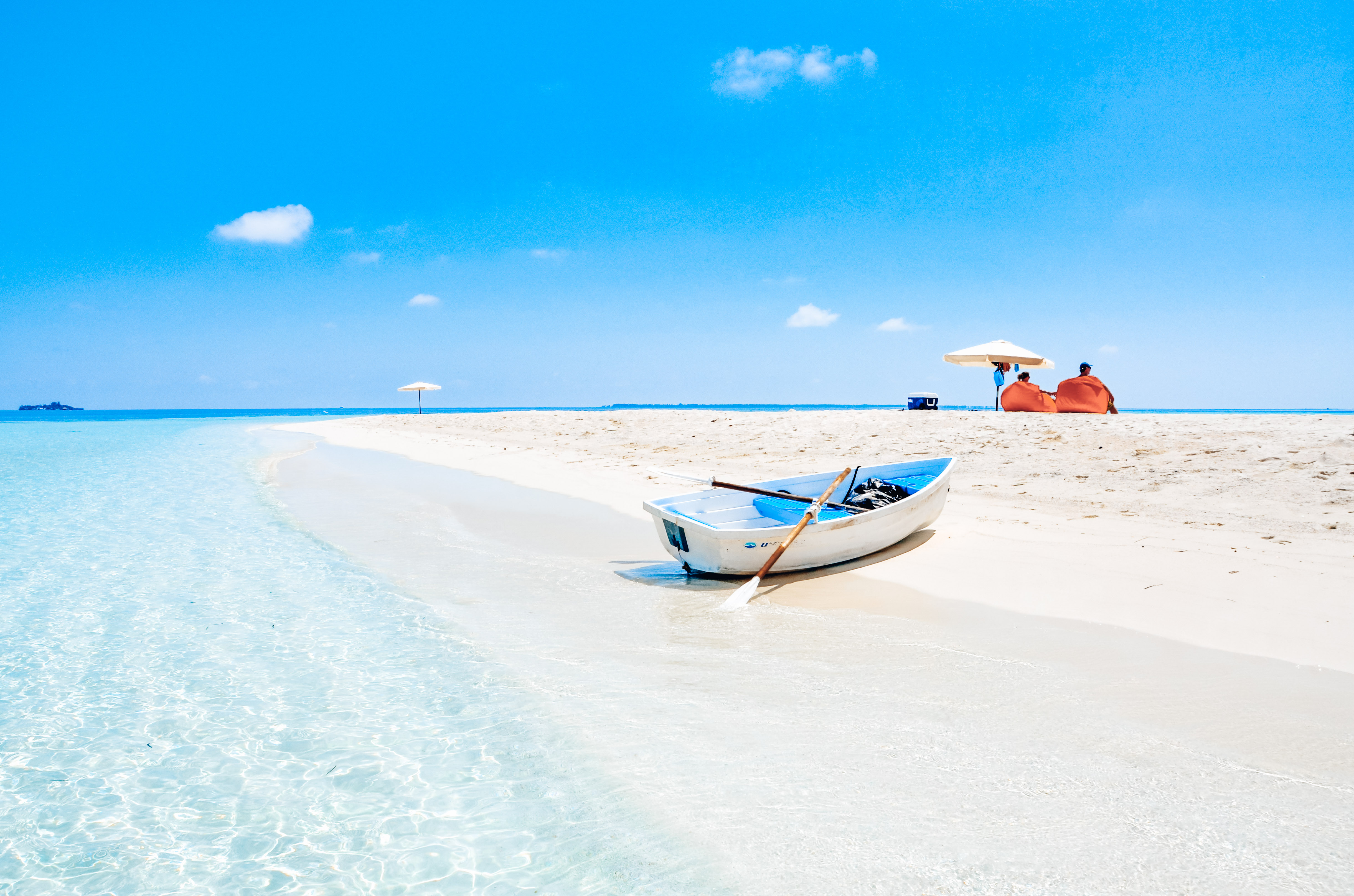 Beautiful white sand beach with calm turquoise waters perfect for family swimming